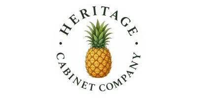 A pineapple is centered with “Heritage Cabinet Company” written in a circle around it.